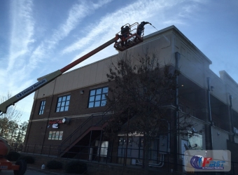 Commercial building exterior being pressure washed