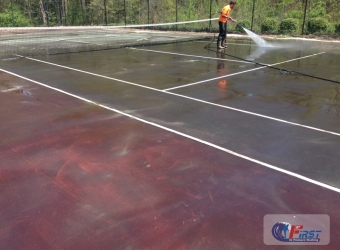 Tennis court being pressure washed