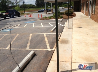 Commercial parking lot and concrete sidewalk before pressure washing