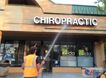 Commercial building facade being pressure washed
