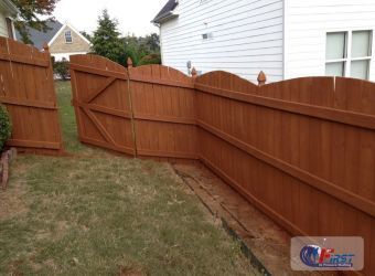 Clean wooden fence after pressure washing