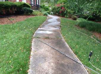 Dirty concrete walkway before pressure washing