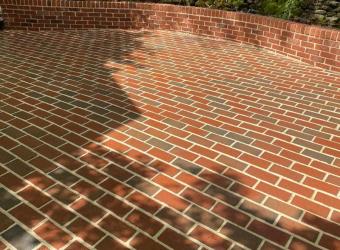 Clean brick patio after pressure washing