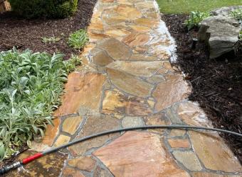 Clean stone walkway after pressure washing