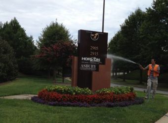 Commercial property sign being pressure washed